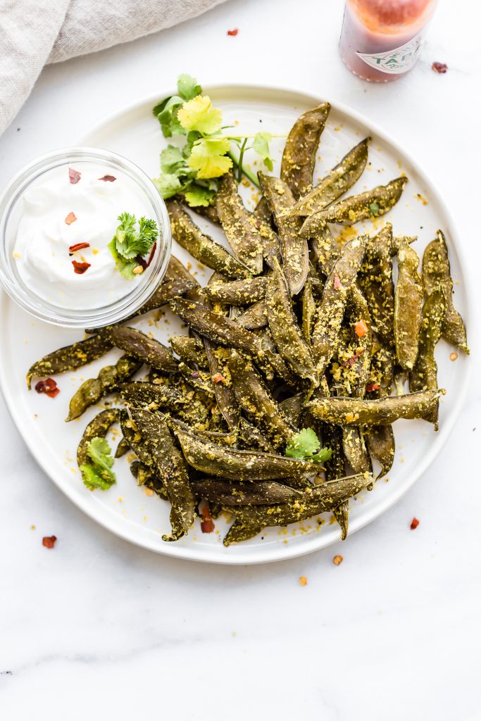 How to Make Homemade Snap Pea Chips in the oven or dehydrator! Have you ever wanted to make your own snap pea chips and save on money? Well, it's quite easy. Just season to your liking and pop in the oven or dehydrator. All it's takes is 3 ingredients! A Vegan, Paleo, and budget friendly snap pea chips recipe.