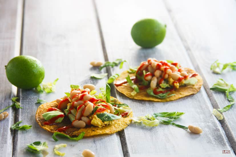 This Gluten Free Tostadas recipe is made with egg and white beans, and it's topped with a spicy chili sauce. It's a great vegetarian meal any time of day!