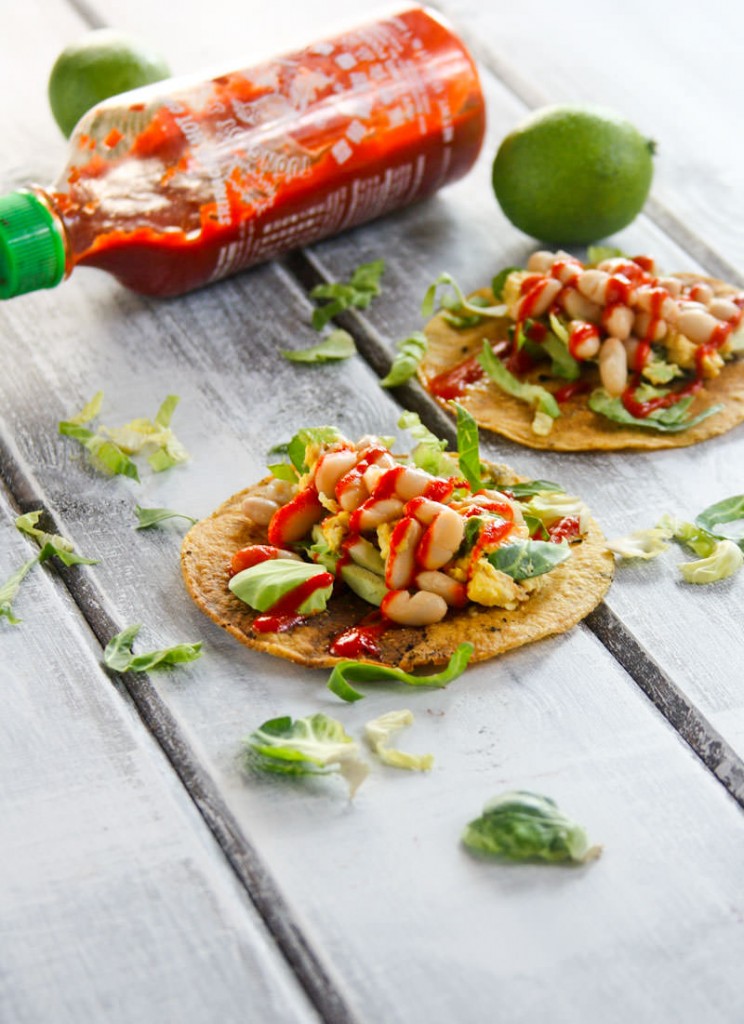 This Gluten Free Tostadas recipe is made with egg and white beans, and it's topped with a spicy chili sauce. It's a great vegetarian meal any time of day!
