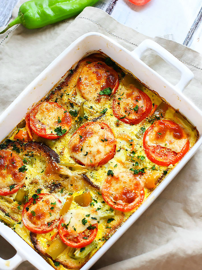 An overhead view of a rectangular white casserole dish of Hatch Green Chile and Tomato Egg Casserole.