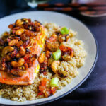 Green Curry Salmon and Cashew with Quinoa! Sweet and spicy green curry combined with cashews, salmon, and dried fruit! A healthy flavorful meal that is packed with anti-oxidants and comes together in 30 minutes! Great by itself or served on top of garlic quinoa.