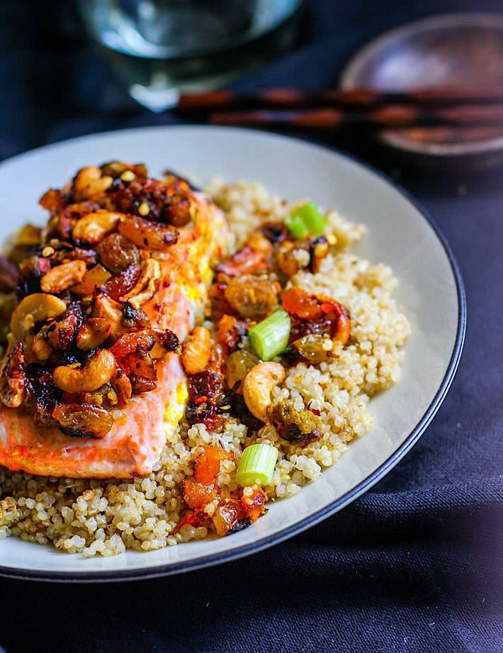Green Curry Salmon and Cashew with Quinoa! Sweet and spicy green curry combined with cashews, salmon, and dried fruit! A healthy flavorful meal that is packed with anti-oxidants and comes together in 30 minutes! Great by itself or served on top of garlic quinoa.