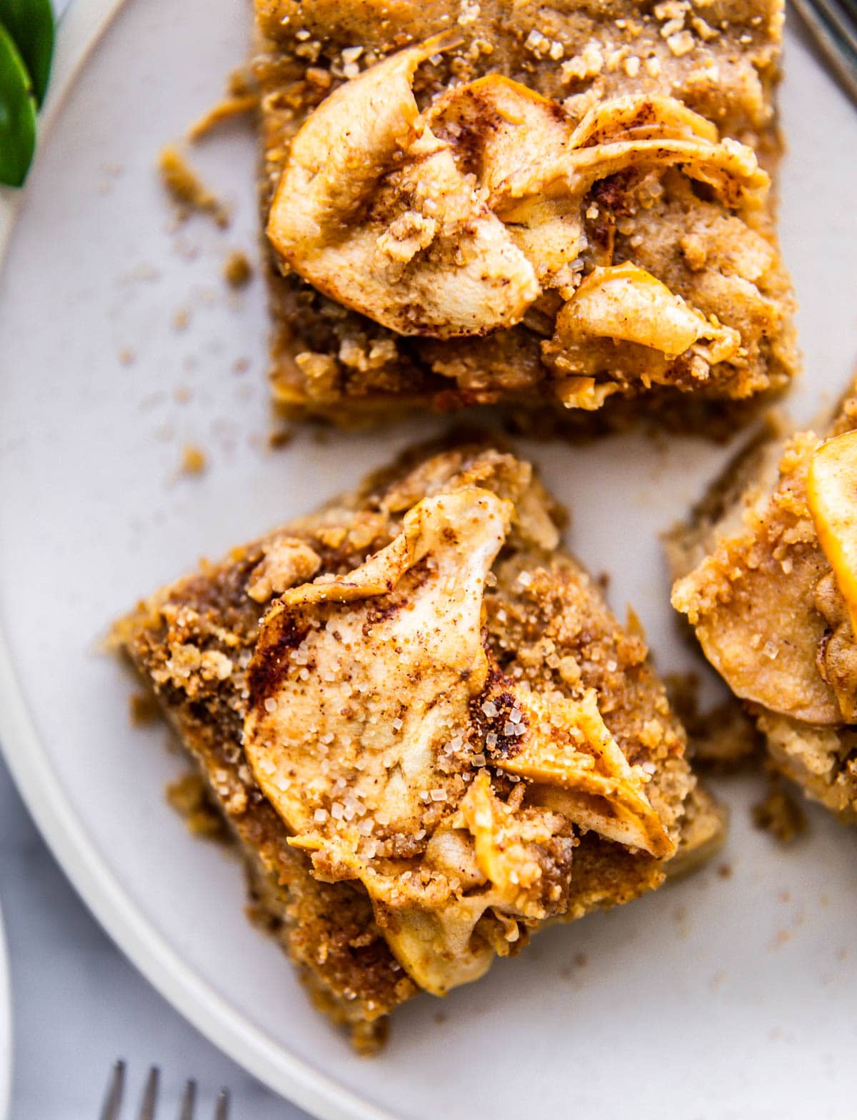 Three servings of almond flour apple coffee cake on white plate
