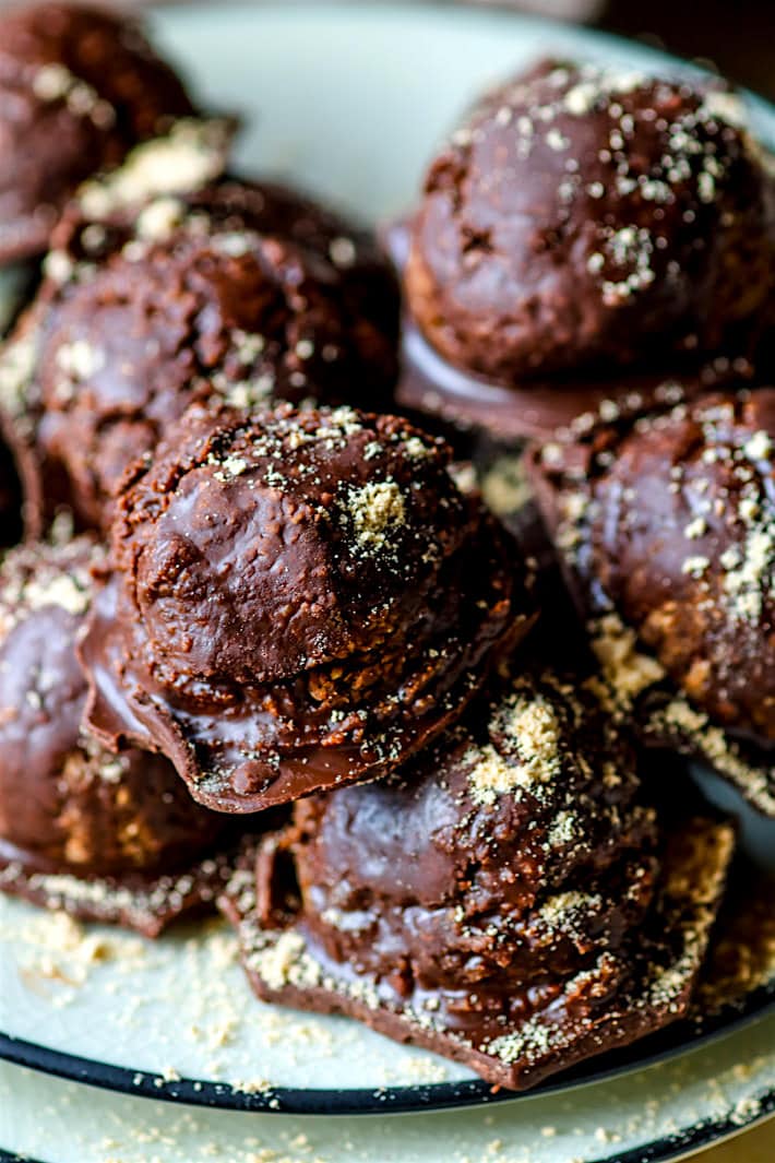 Close up view of gluten-free chocolate peanut butter energy bite with magic shell of hardened chocolate coating each bite.
