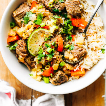 Overhead view Hawaiian beef over rice in white bowl.