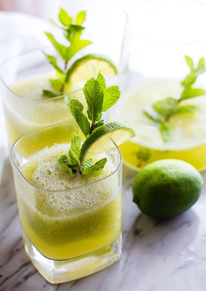 3 glasses filled with mint melon limeade and fresh min to garnish