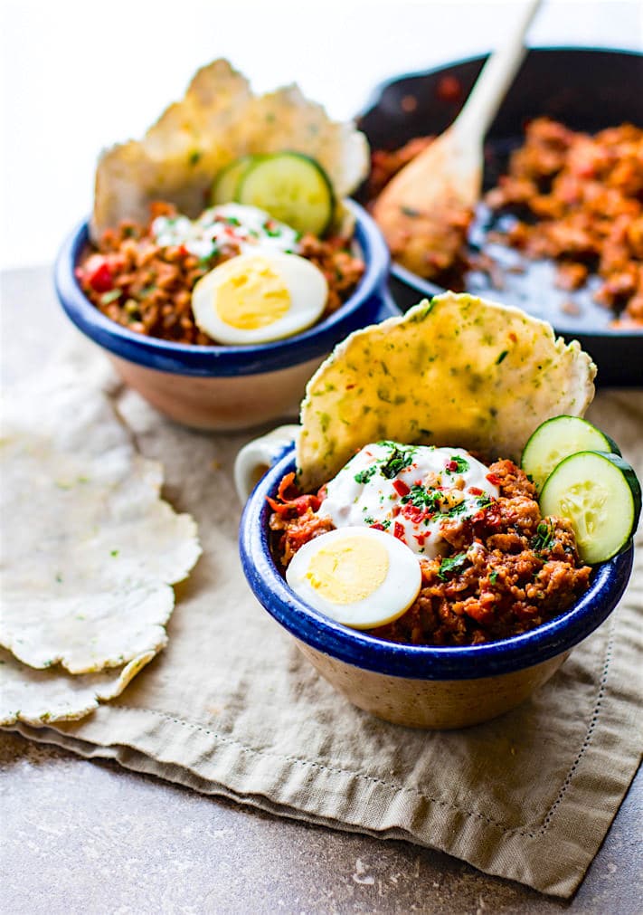 Grain Free Turkish Style Savory Breakfast Bowls. One pan is all you need to make these healthy savory breakfast bowls. Filled with spicy breakfast sausage, herbs, veggies, egg, and a tangy yogurt topping! Great for breakfast, brunch, or dinner.