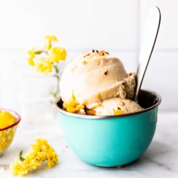 2 scoops of banana coconut milk nice cream in robin's egg blue ice cream bowl with spoon