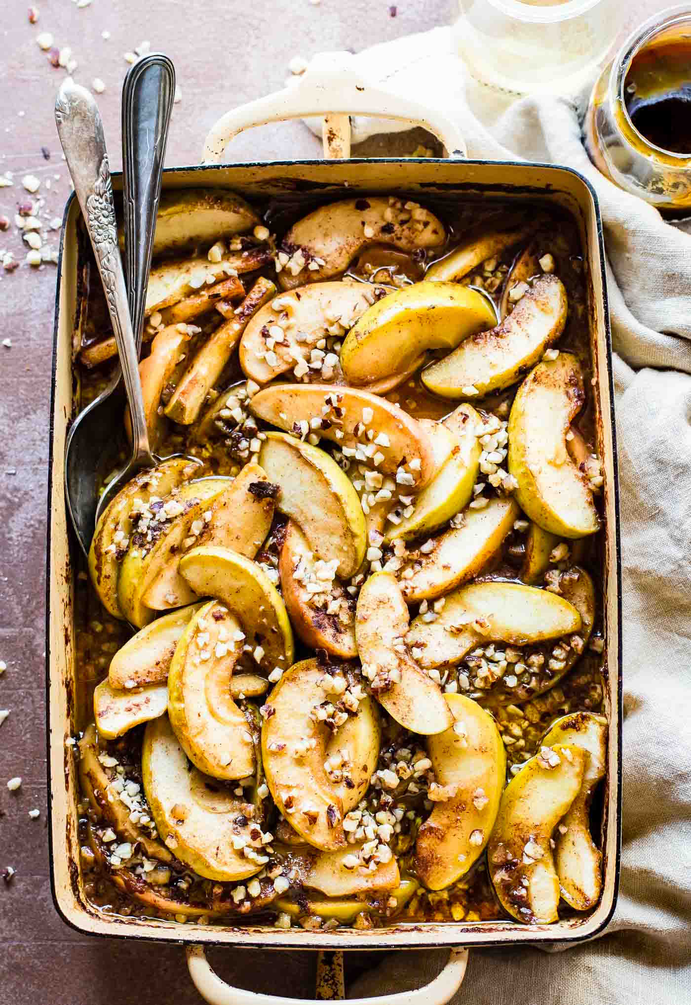 overhead view casserole dish filled with cider baked apple slices