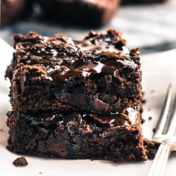 2 plated vegan brownies covered in dairy free salted caramel sauce