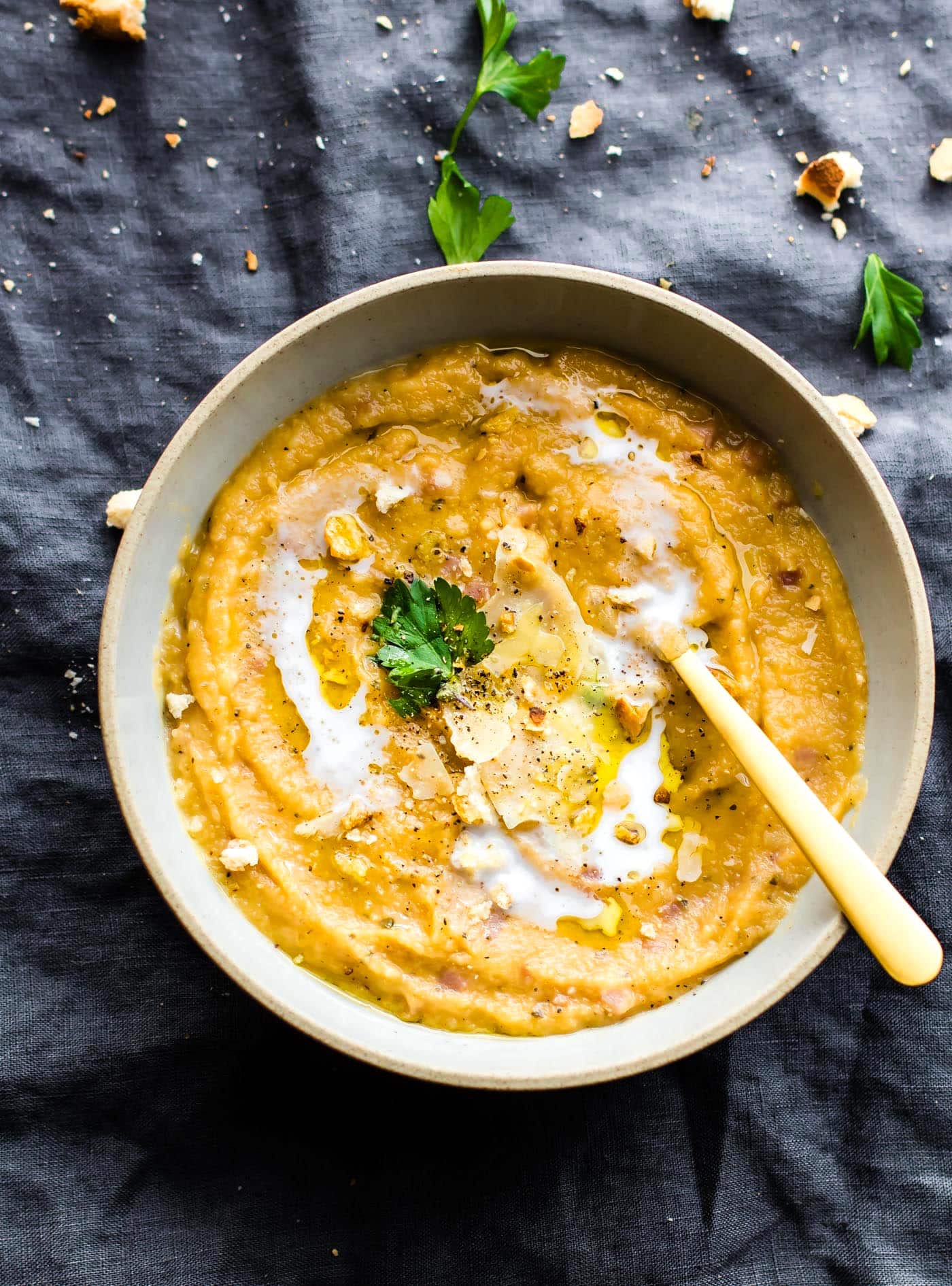 a bowl of homemade ham and vegetable soup with a spoon in it.