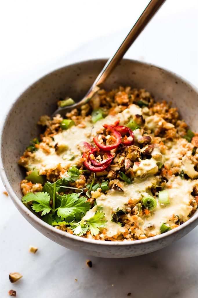 Colorful Thai Cauliflower Rice Salad is packed full of flavor, spice, and made easy! It's one of my absolute favorite healthy light lunch recipes! Thai spiced mixed into a Carrot Cauliflower Rice Salad with Avocado Cream Dressing. It's Paleo, Vegan, and made in under 30 minutes. Perfect as is, or with a protein of choice