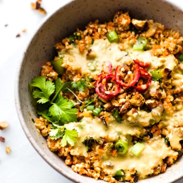 Thai Cauliflower Rice Salad is packed full of flavor, spice, and made easy! Thai spices mixed into a carrot cauliflower rice salad with avocado cream dressing! Paleo, Vegan, and made in under 30 minutes.