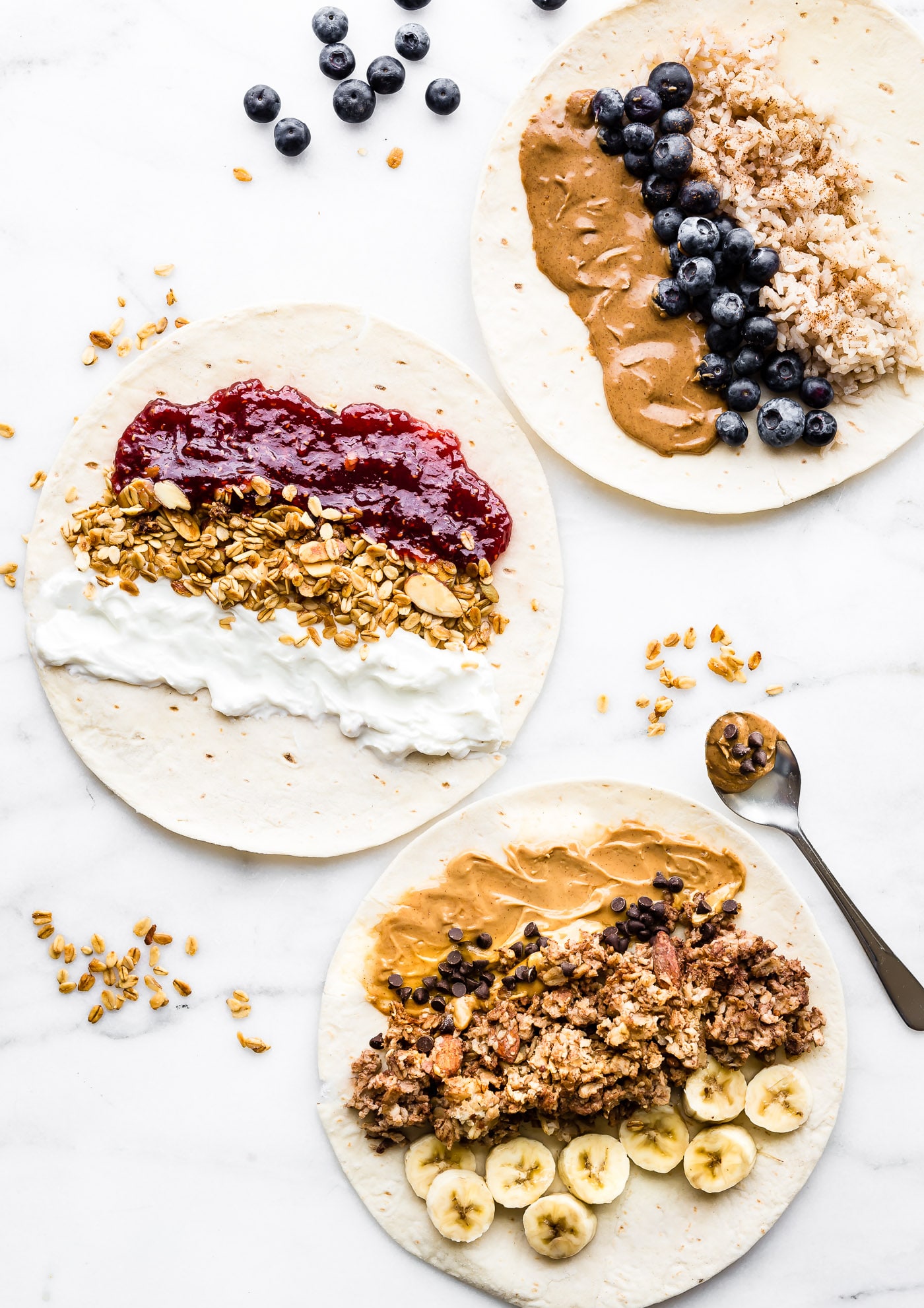 3 breakfast wraps being filled with healthy ingredients like blueberries, almond butter, oatmeal, and brown rice