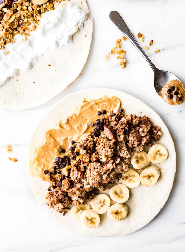 gluten free breakfast wrap (open faced) with slices of banana, cooked chocolate oatmeal and nut butter