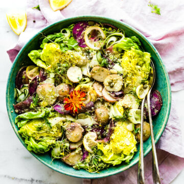 overhead image of a wedge salad with spring pesto sauce and baby potatoes