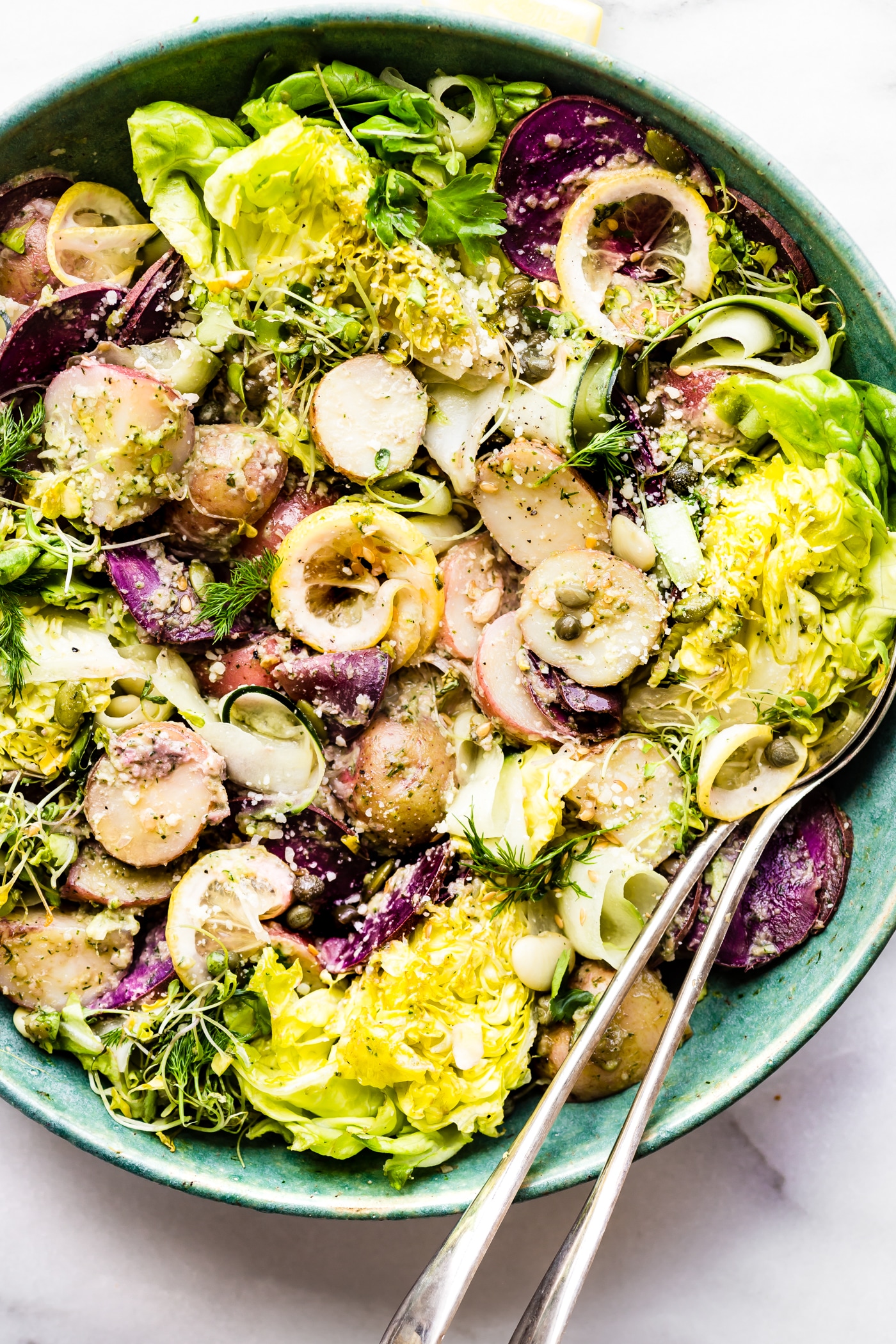 This Dill Pesto Potato Wedge Salad makes a great healthy side dish for your next barbecue or gathering! A crunchy wedge salad and creamy potato salad all packed into one then tossed a zippy dill pesto sauce. It's gluten free, paleo/vegan friendly, and super easy to make.