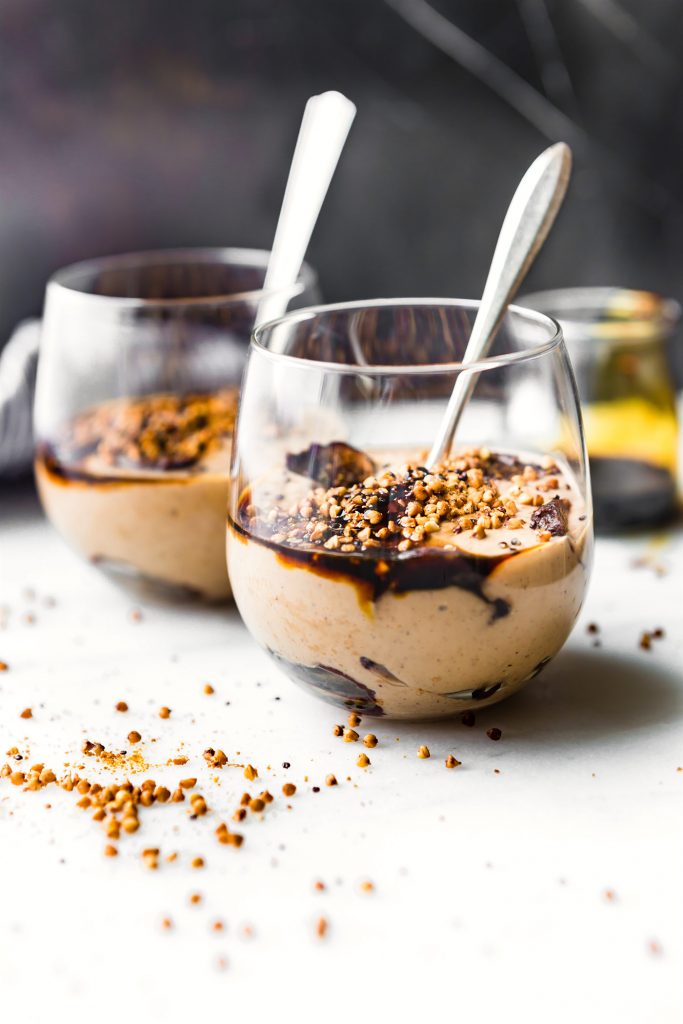 Creamy Yogurt Parfait Cups with sliced fig and a spoon in it.