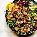 Herb roasted panzanella fall salad with croutons in black stone.