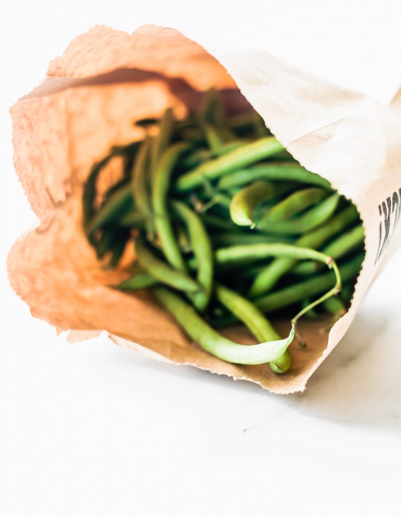 paper bag full of fresh green beans.