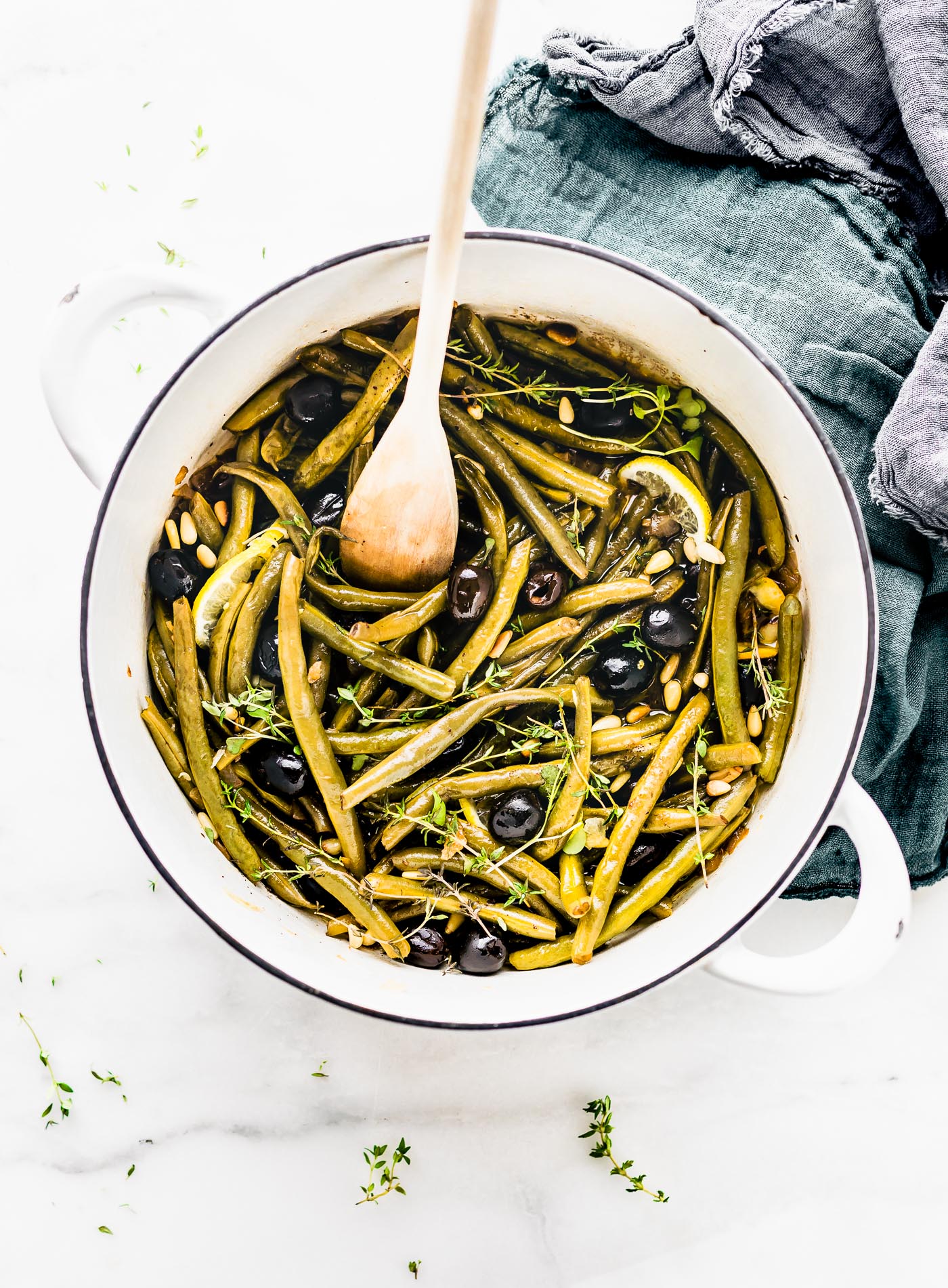 Balsamic Olive-Oil braised green Beans in Dutch oven with wooden spoon.