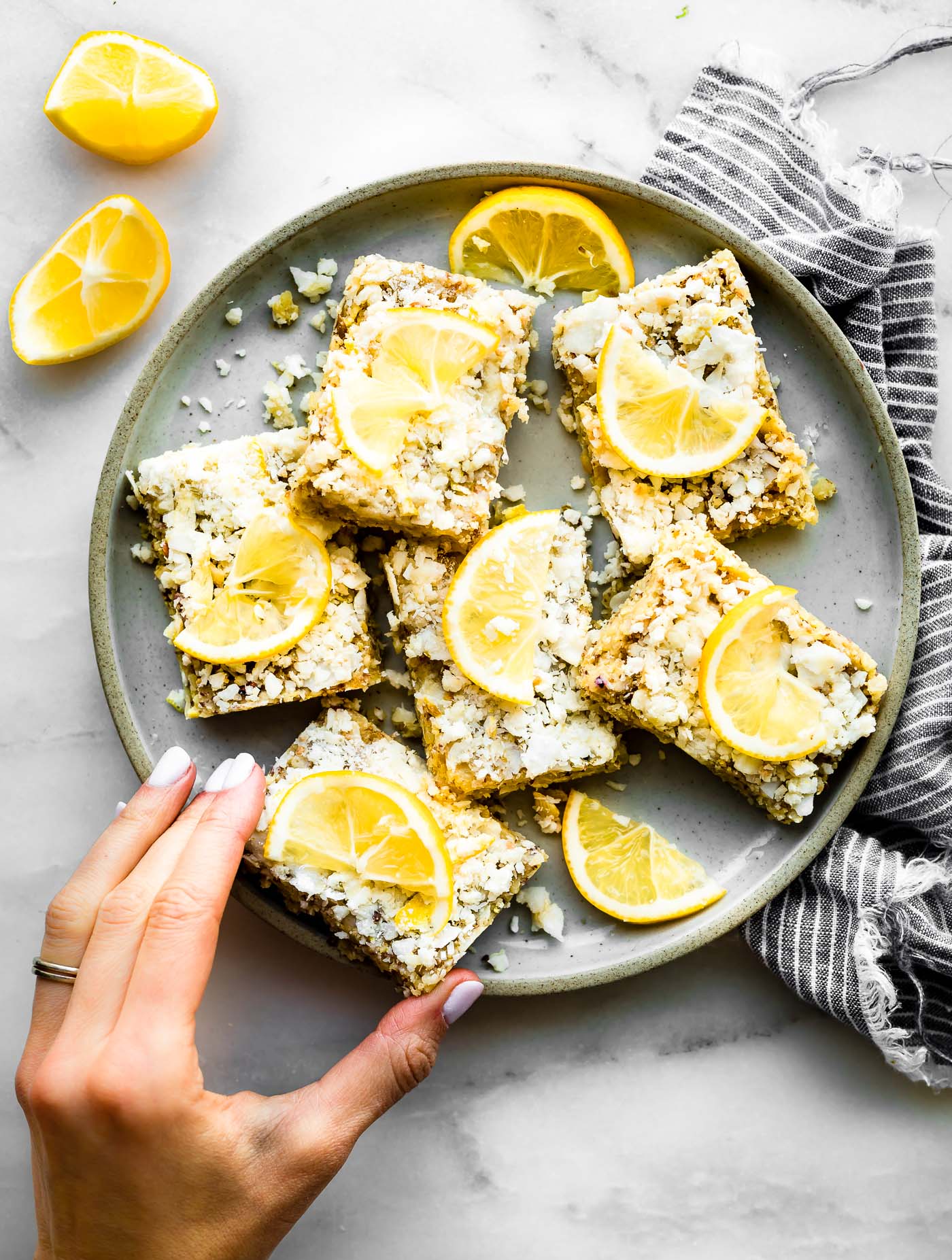 Overhead view several no bake lemon coconut energy bars on a plate.