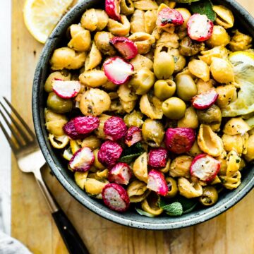 roasted radishes with lemony chickpea pasta in stone bowl.