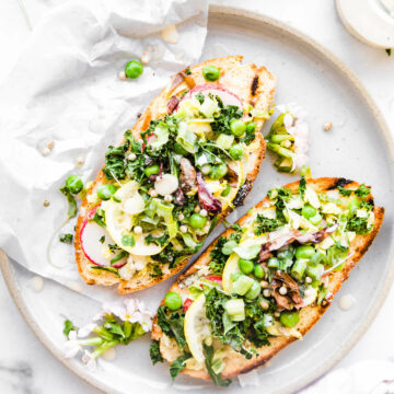 spring vegetable salad open faced sandwiches on stone plate