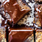 Overhead close up view dirty chai flourless brownie squares topped with glossy dark chocolate