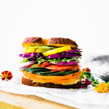 gluten free farmer's market veggie sandwich on wooden cutting board