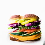 Extra full veggie sandwich on white counter