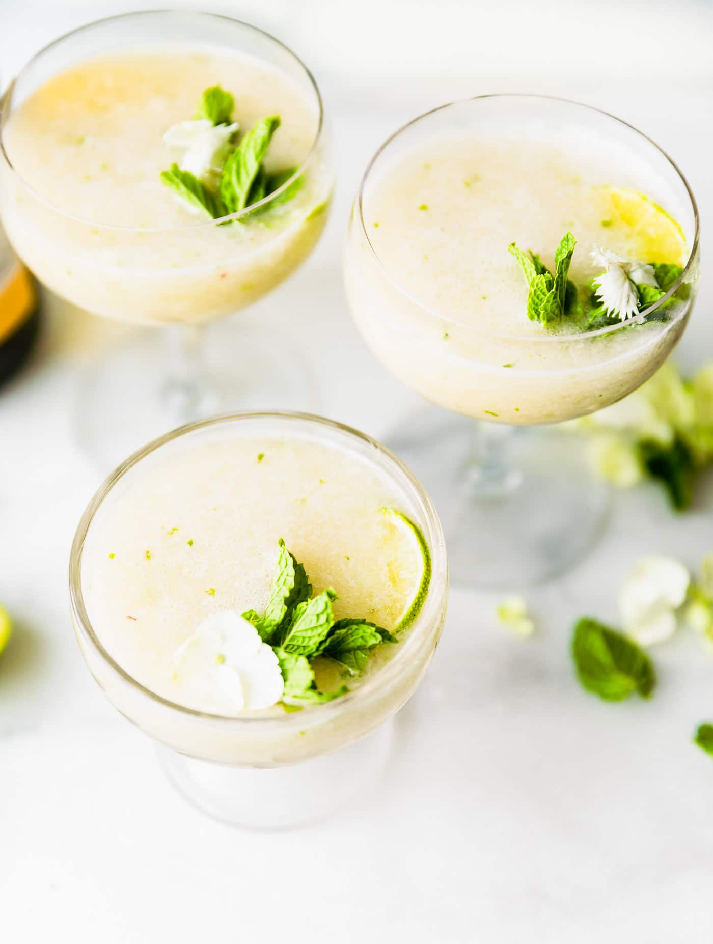 overhead photo of frozen wine cocktails garnished with fresh mint