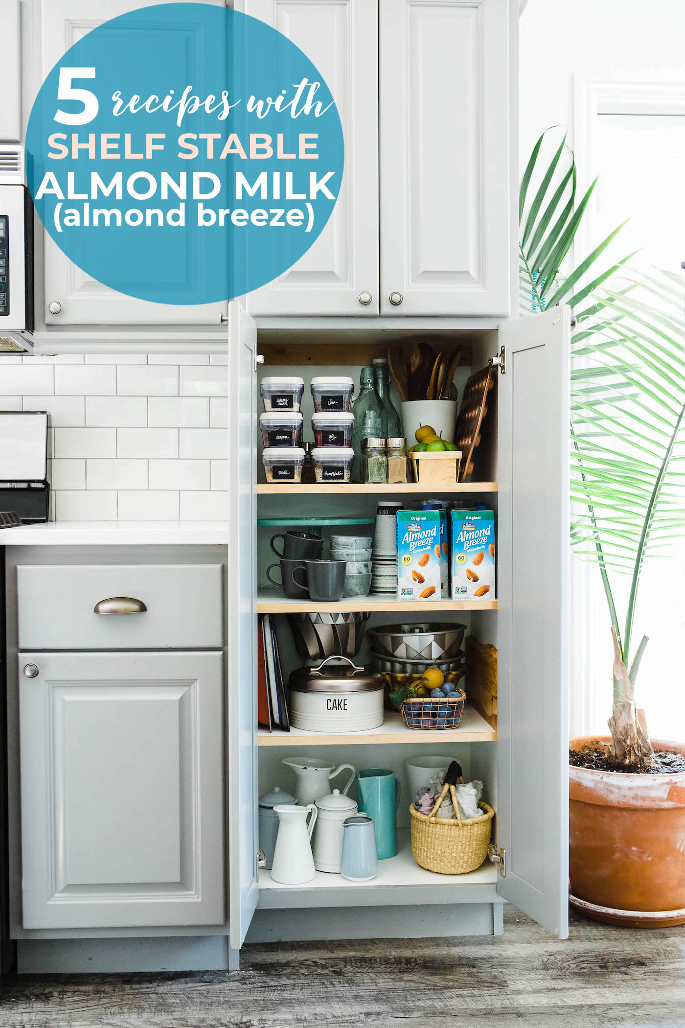 A white and grey pantry cupboard door open to show bake wear and Almond Breeze almond milk containers.