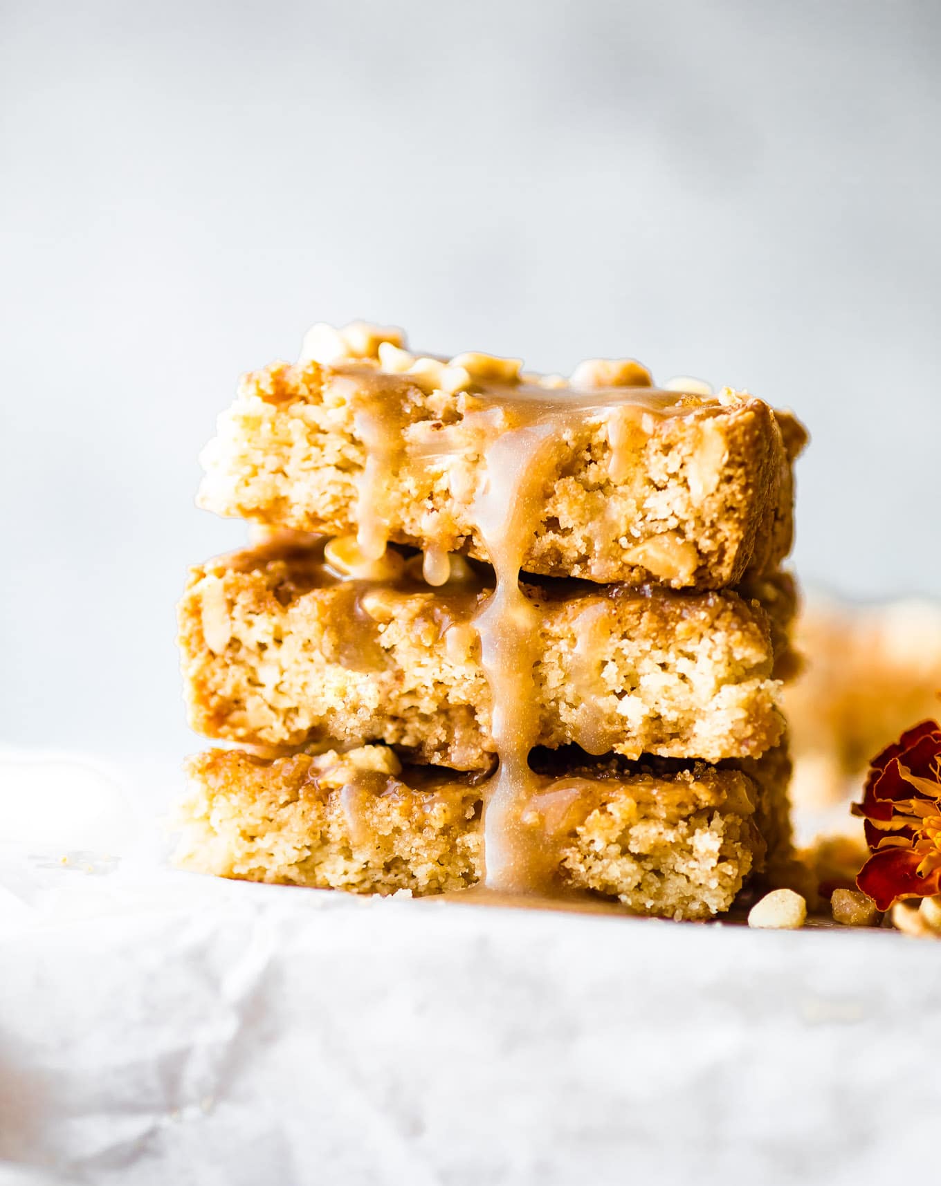 maple bars stacked on top of each other with caramel drizzling down the sides.
