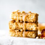 Three maple bars topped with maple glaze stacked up on each other.