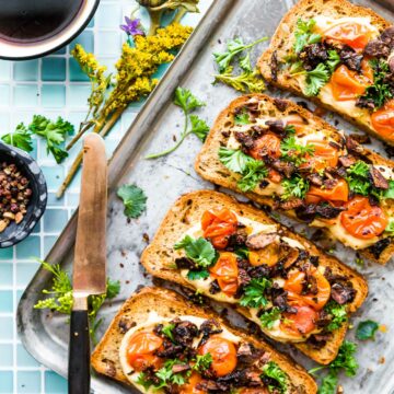Mushroom Bacon Breakfast Toast is a plant-based, gluten-free breakfast recipe that will transform the way you think of toast! A vegan bacon substitute, made from smoky mushrooms, sits on a bed of hummus with tomato and fresh herbs. This healthy hummus toast is full of protein, fiber, and flavor. #breakfastrecipes #hummustoast #veganbacon