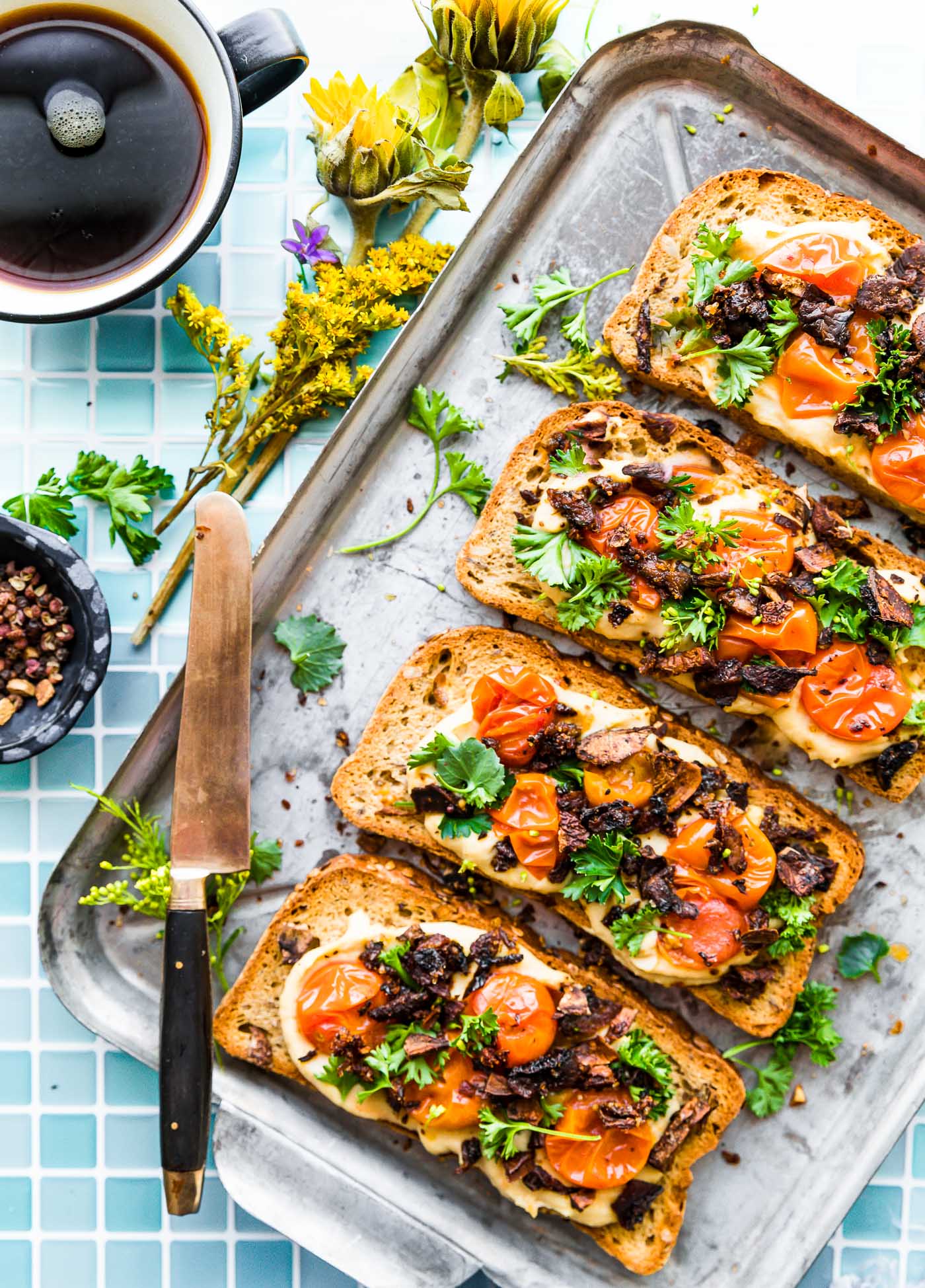Mushroom Bacon Breakfast Toast is a plant-based, gluten-free breakfast recipe that will transform the way you think of toast! A vegan bacon substitute, made from smoky mushrooms, sits on a bed of hummus with tomato and fresh herbs. This healthy hummus toast is full of protein, fiber, and flavor.  #breakfastrecipes #hummustoast #veganbacon