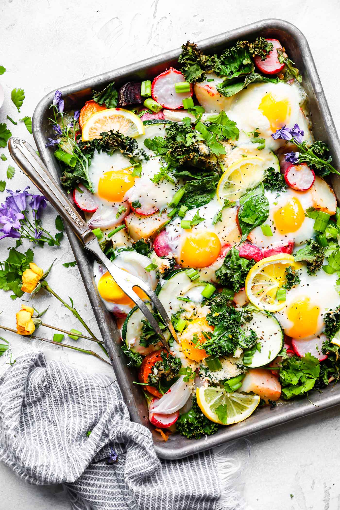 Baked Eggs with Roasted Spring Vegetables is an easy sheet pan meal for breakfast, brunch, or dinner. It's a great way to enjoy the harvest of spring veggies with a boost of protein from organic eggs! This is a gluten-free, lower carb, vegetarian recipe with a Paleo/Whole 30 option, too! 