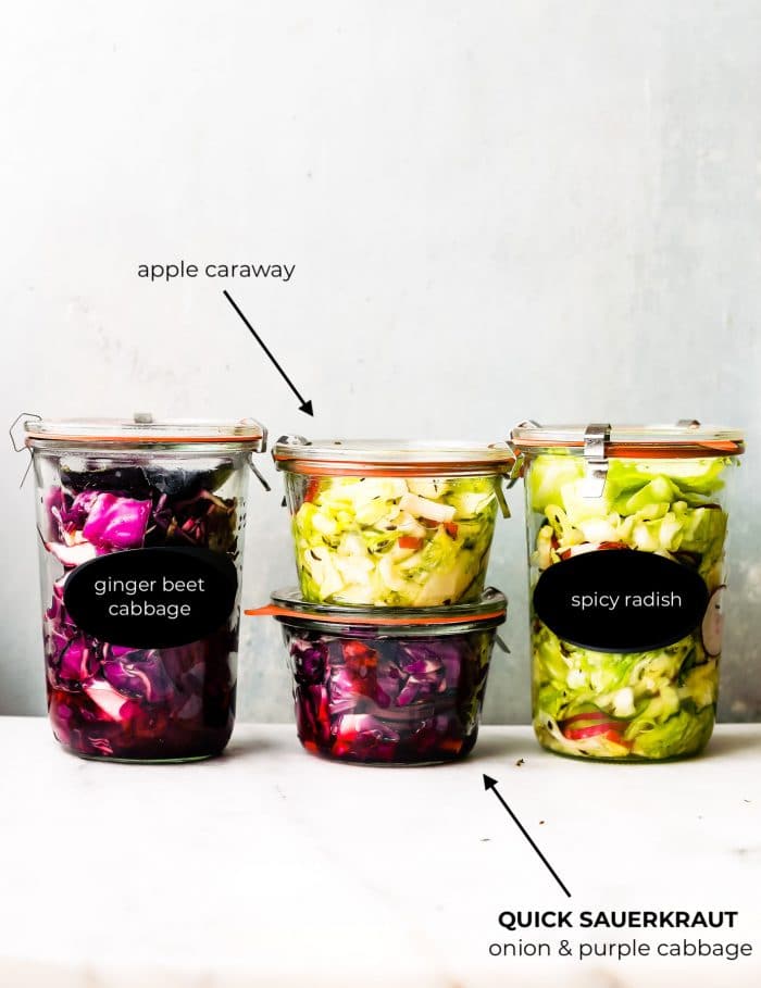 4 canning jars of homemade sauerkraut with lids
