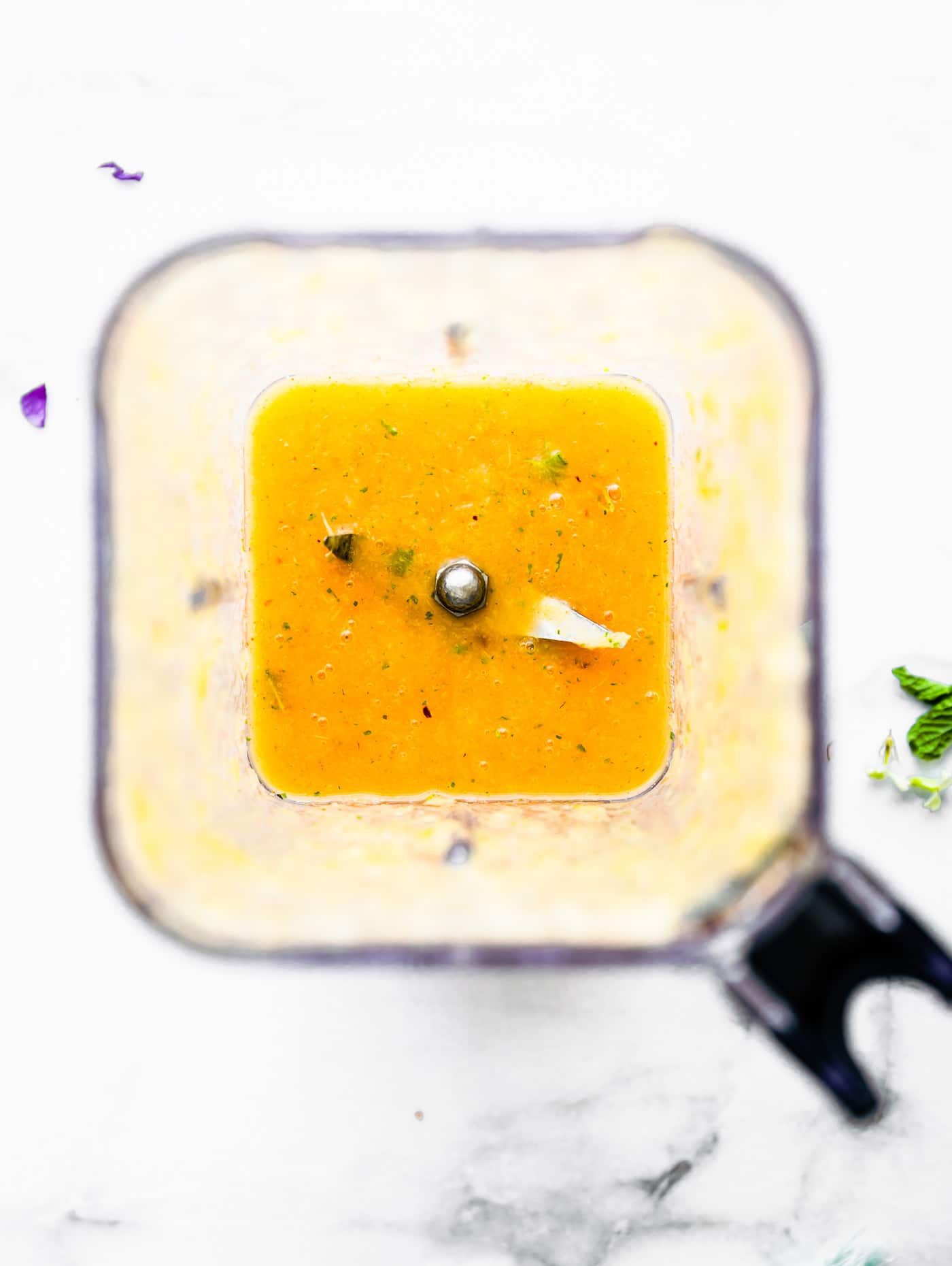 Overhead photo of a blender with blended detox apple cider vinegar drink recipe.