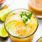 Overhead photo of a detox apple cider vinegar drink recipe topped with mint and lime.
