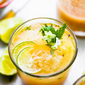 Overhead photo of a detox apple cider vinegar drink recipe topped with mint and lime.