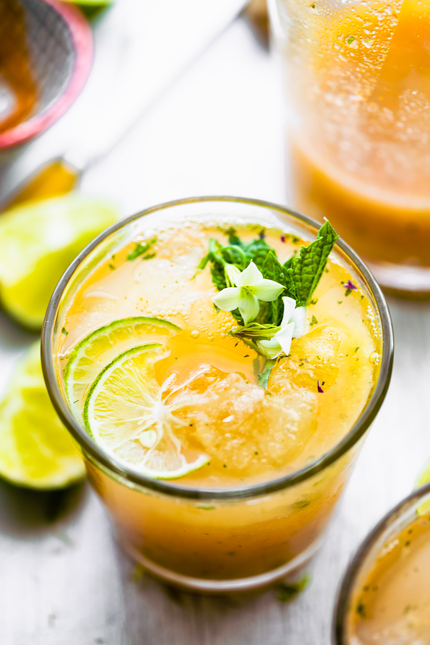 Overhead photo of a detox apple cider vinegar drink recipe topped with mint and lime.