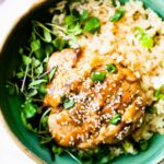 Teriyaki chicken served over rice and microgreens in turquoise bowl