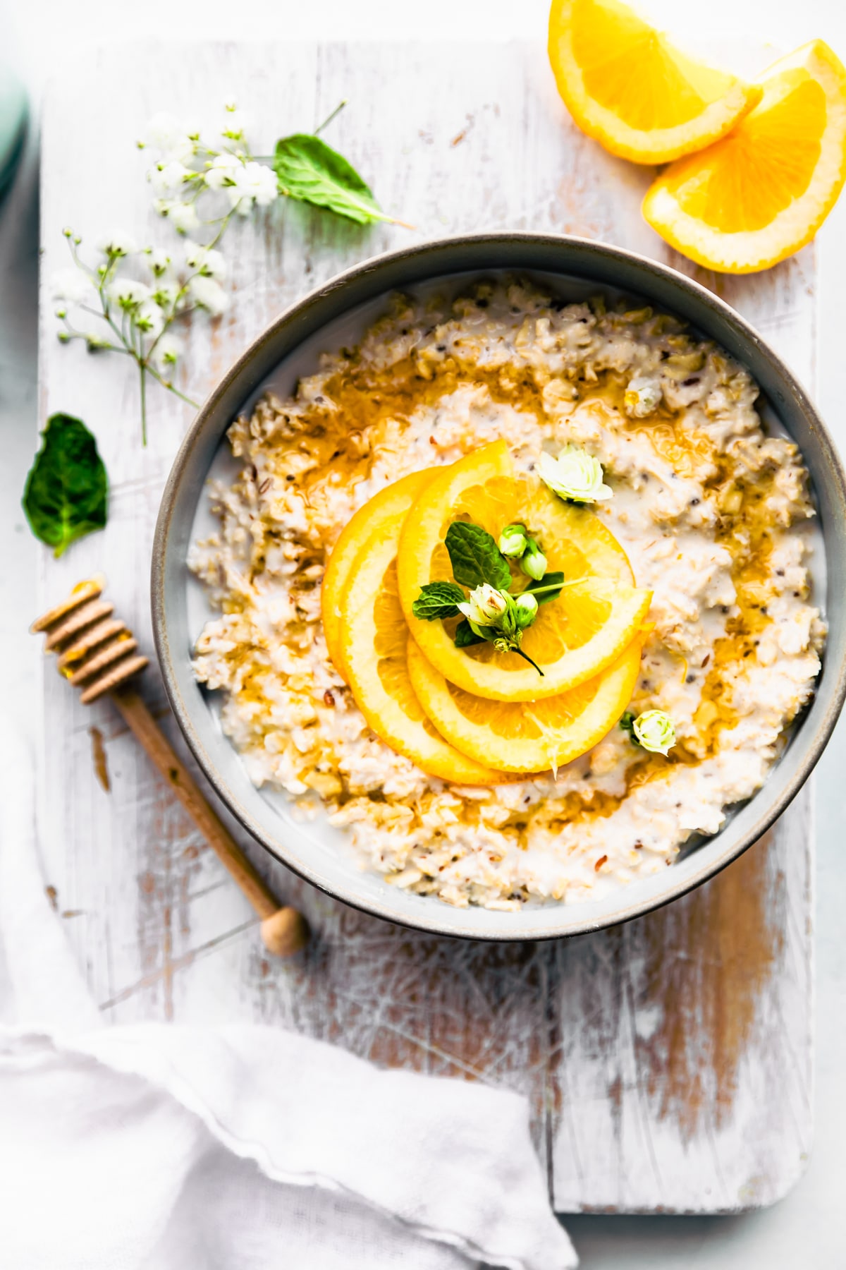 Orange vanilla protein overnight oats served in bowl topped with fresh orange slices