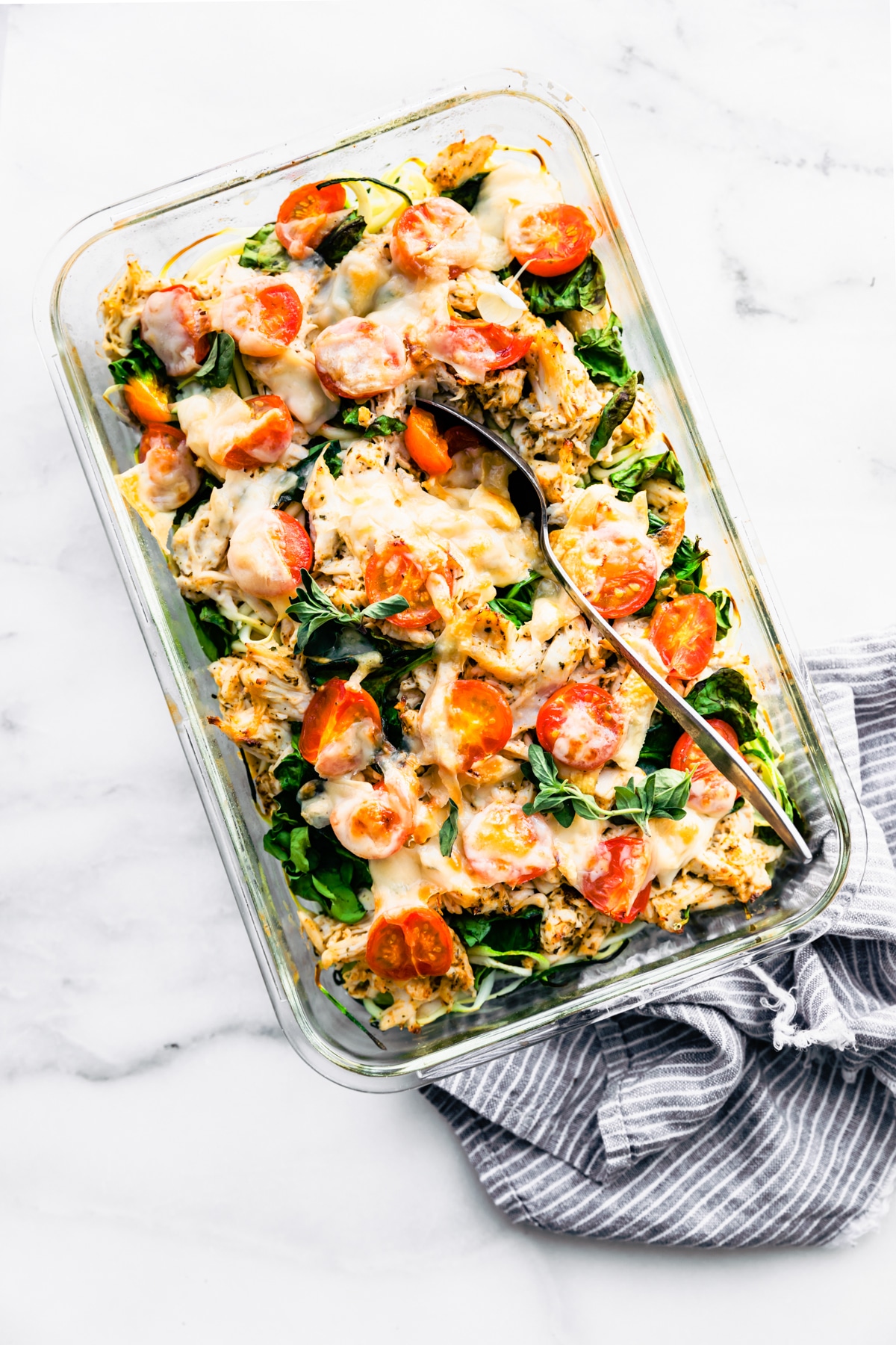 meal prep casserole made with chicken and veggies with melted cheese on top.
