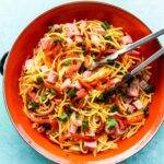 homemade Asian sweet and sour noodles in orange bowl