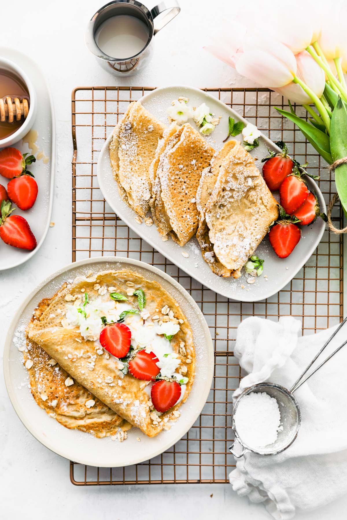 plated oatmeal crepes topped with fresh strawberries