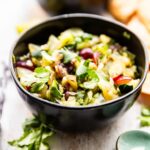 fresh salsa recipe in a black bowl - made with jalapeno, grapes and cucumbers