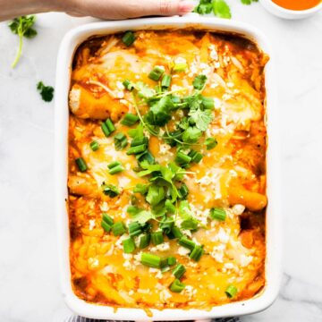 easy enchiladas casserole in rectangular white baking dish